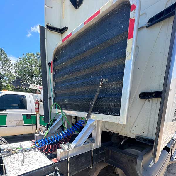 Picture of a diesel truck getting an airline replacement on the roadside