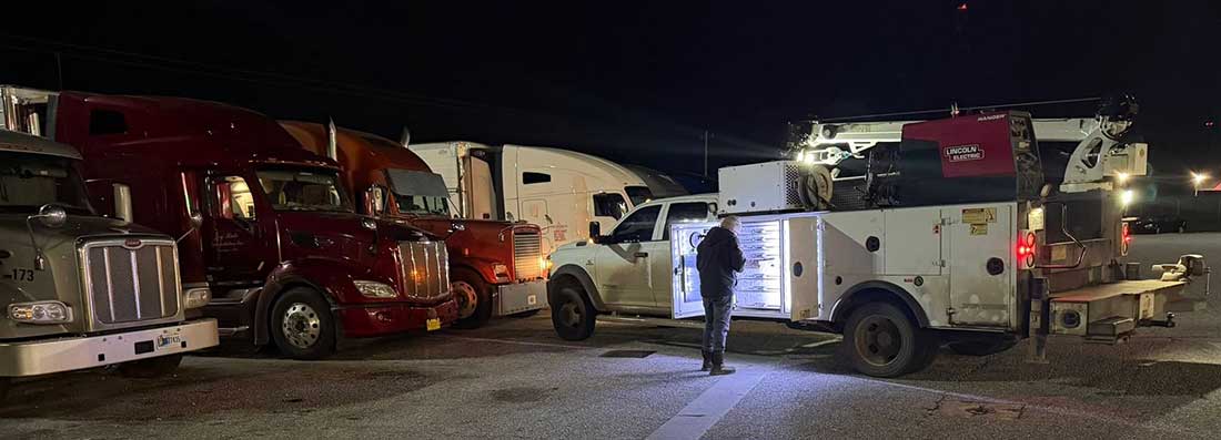 Diesel Mechanic responds to a call for a semi truck breakdown Diesel Mechanic Working on a Semi Truck that broke down at night